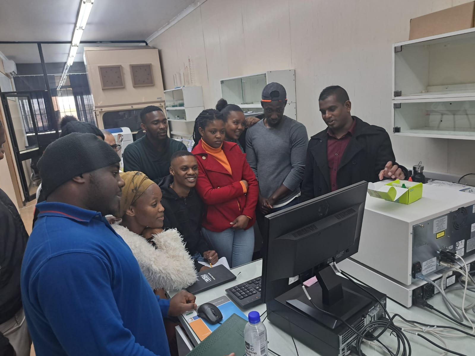 Health researchers gathered around laboratory equipment